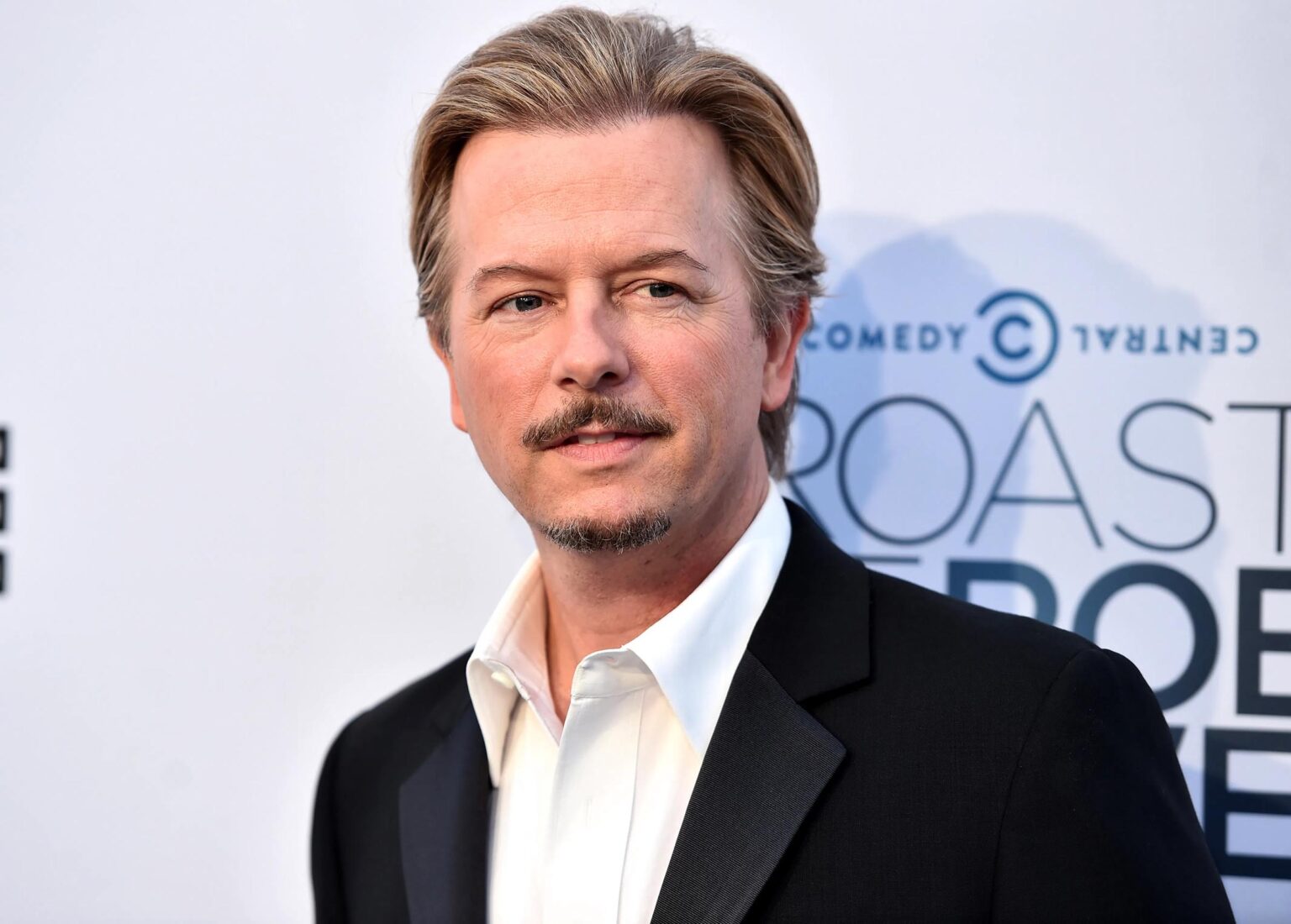 Hollywood comedy star David Spade is set to host the upcoming 'The Netflix Afterparty.' What does this mean for his net worth?
