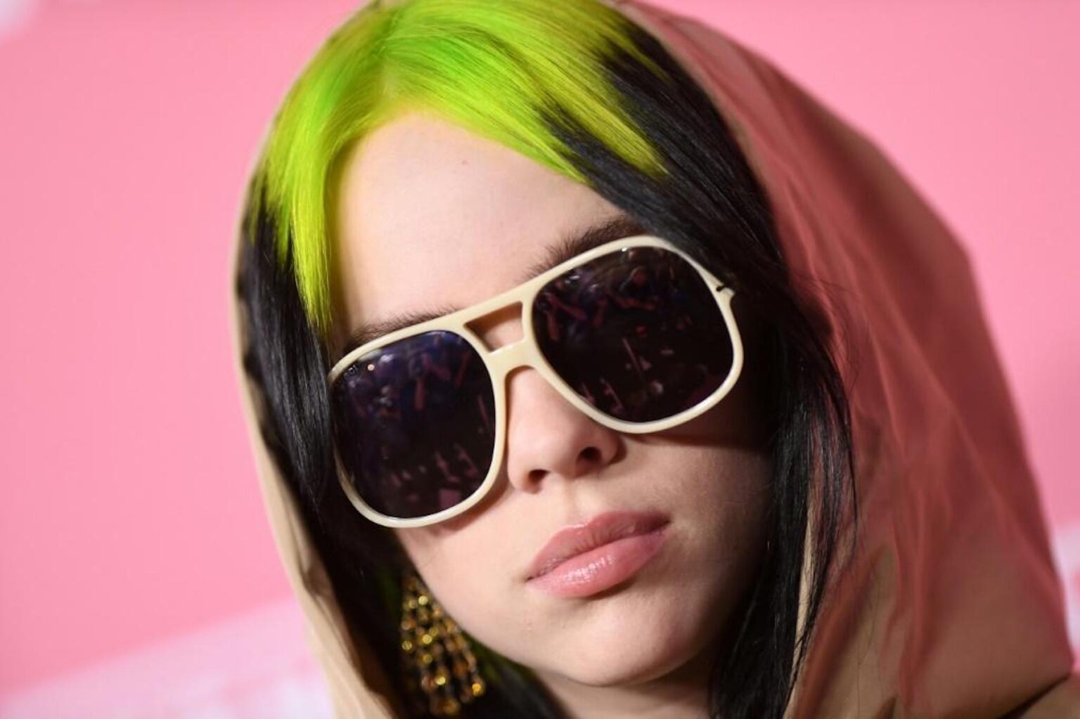 Billie Eilish gets real about her past body struggles and how she feels about the tank top photo. Read on to hear the singer's thoughts.
